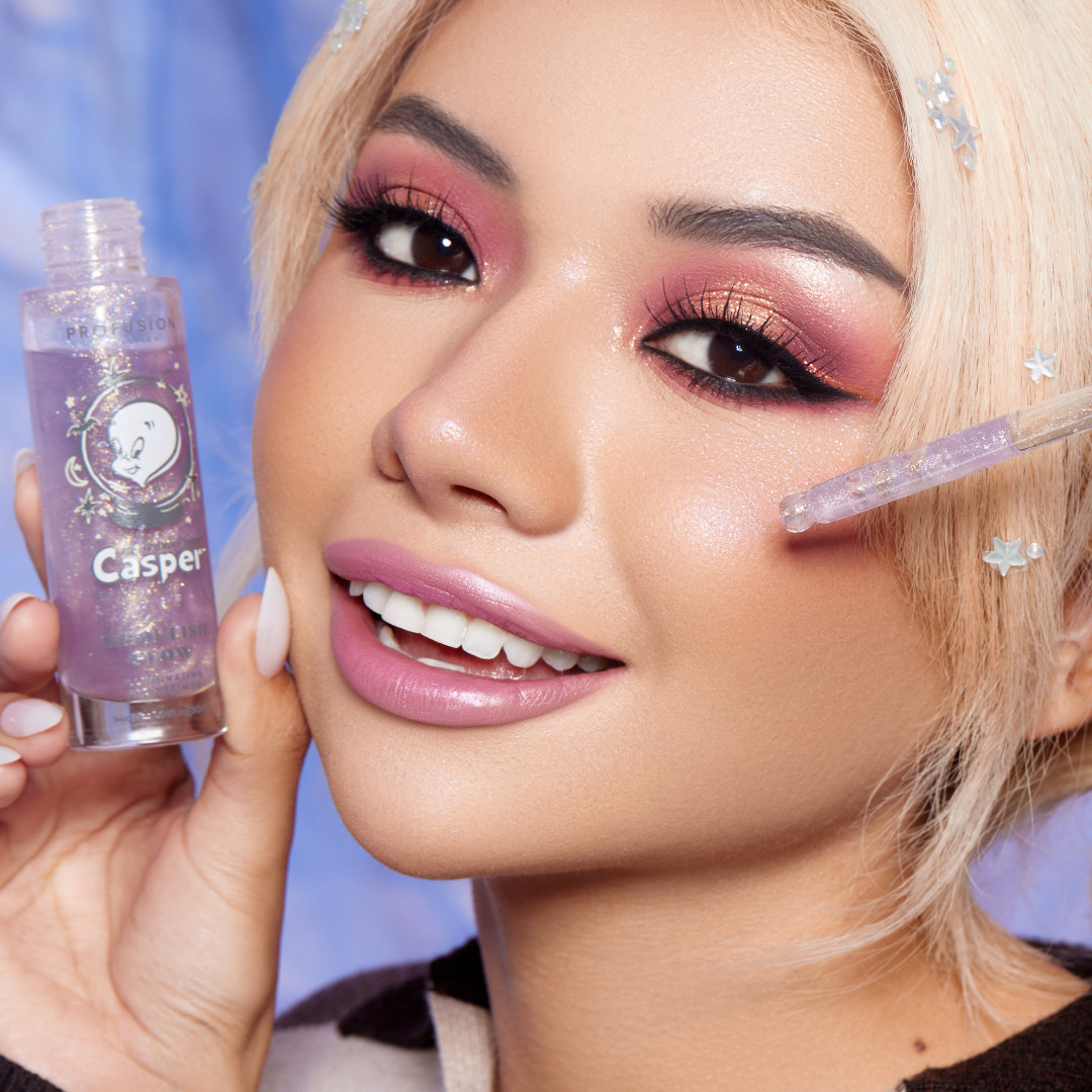 model holding an opened bottle of face liquid primer