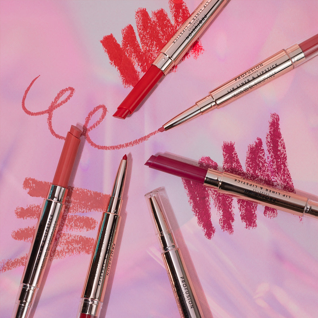 Lip liners and swatches in red, pink, and mauve shades on a colorful background.