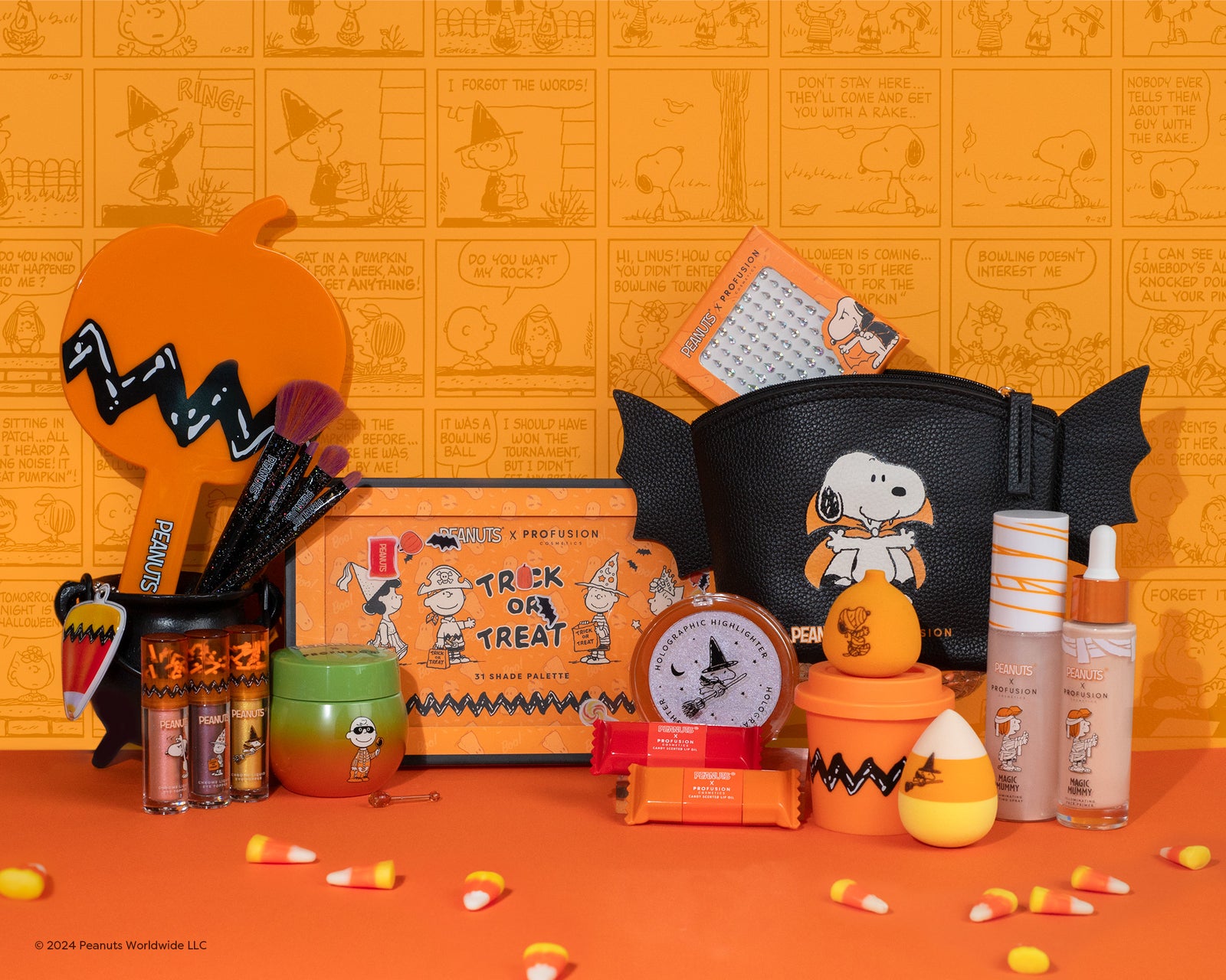 Profusion Cosmetics' Peanuts collection featuring vibrant orange and black themed makeup products, including eyeshadow palettes, brushes, and lip oils, makeup bags, and more adorned with Snoopy and Halloween motifs.