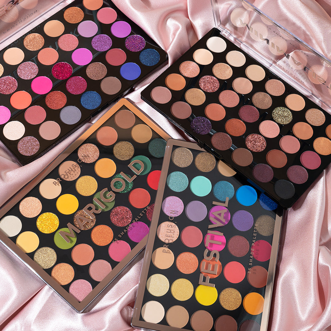 Four Profusion Cosmetics glittery eyeshadow palettes, including "Festival" and "Marigold," featuring vibrant shades on a silky pink background.