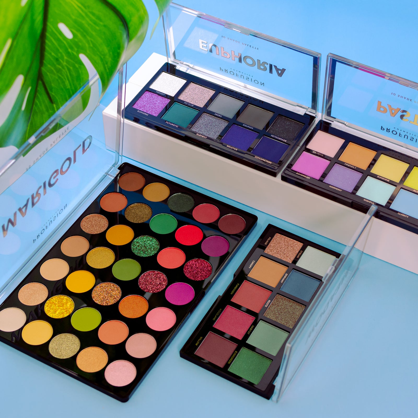 A vibrant display of Profusion Cosmetics eyeshadow palettes featuring bold colors like greens, blues, and pinks from various collections.
