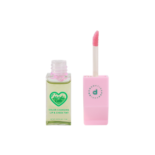 Profusion Cosmetics' "Matcha Latte" color-changing lip and cheek tint with the applicator placed upright next to it.
