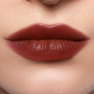 Close-up of lips wearing Profusion Blackberry Glaze, showing a deep brown-berry tint with a soft glossy finish.