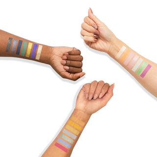 Arm swatches of Profusion Cosmetics Dreamscape eyeshadow palette showing vibrant matte and shimmer shades applied on three different skin tones