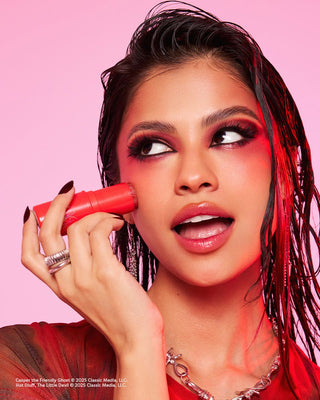 Model applying the Are You Hot Like Me Moisturizing Face & Body Highlight Balm from the Casper & Hot Stuff x Profusion collaboration