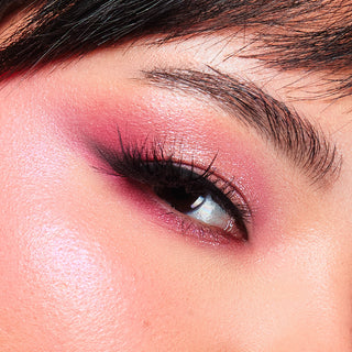 Close-up of an eye wearing vibrant pink and mauve eyeshadow from Profusion Cosmetics, highlighting the shades' rich pigmentation and blendability