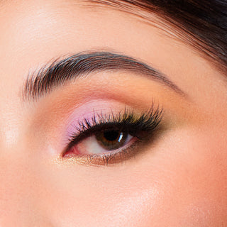 Macro close-up of an eye wearing vibrant pink, orange, and gold Profusion Cosmetics eyeshadow.