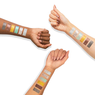 Profusion Cosmetics Kaleidoscope glitter eyeshadow arm swatches in silver, gold, teal, and bronze.