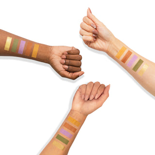 Matte and shimmer eyeshadow swatches in gold, green, lavender, and orange on three skin tones.