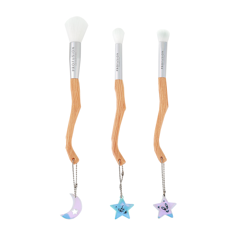 three piece broom shape makeup brush with charms at the end of each brush in shapes of the moon and two brushes with the shape of stars.