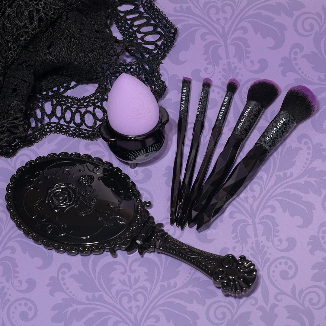 gothic makeup mirror, makeup brush and face sponge.