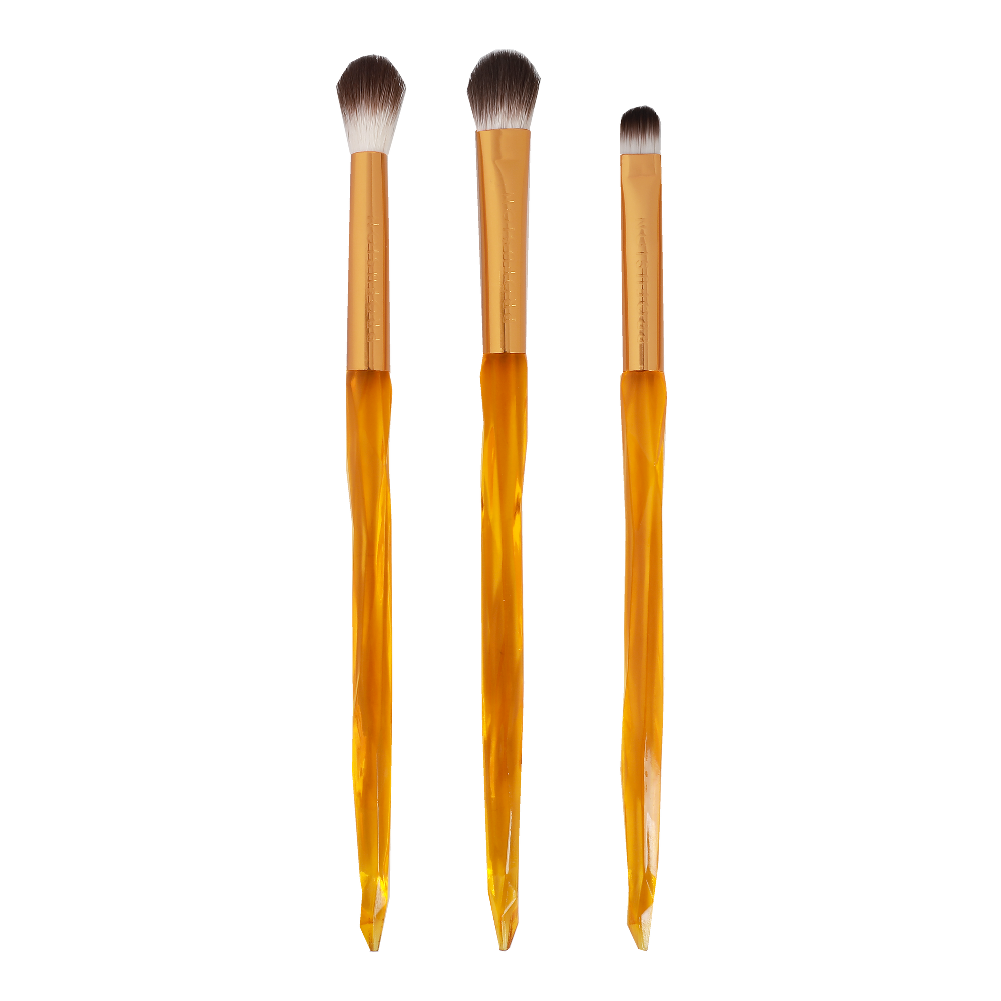 three eyeshadow brushes with amber inspired handles